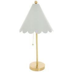 a white lamp with a gold base and a shade on the top, sitting on a white background