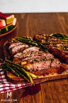 steak and asparagus on a wooden cutting board