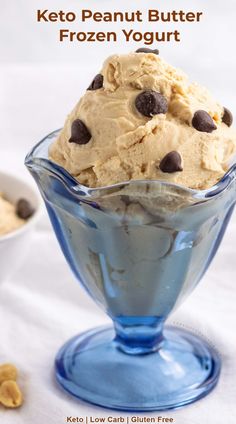 a blue glass bowl filled with ice cream and chocolate chip cookie dough on top of a white tablecloth