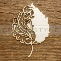 laser cutout of a leaf on wood