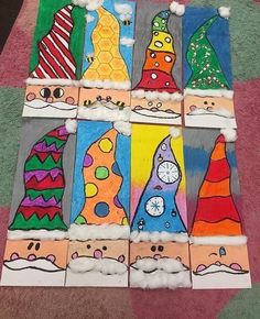 some very cute art work made out of toilet paper with different hats and colors on them