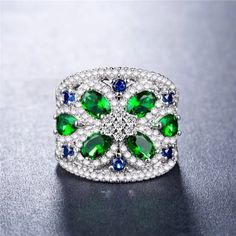 925 Stamped Elegant Cubic Zirconia Flower Ring For Parties, Silver Dazzling Flower Ring For Formal Occasions, Classic White Gold Rings For Party, Elegant Green Rings For Parties, Elegant Emerald Ring For Party, Elegant Round Emerald Ring For Party, Classic White Gold Party Rings, Elegant Party Emerald Ring, Cubic Zirconia Flower Ring For Parties