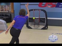 a woman is throwing a tennis ball into the net