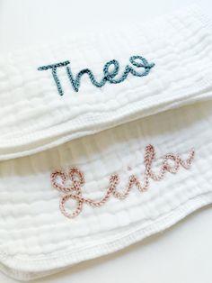 two white towels with embroidered words that spell out the word,'these is love '