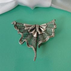 In an abstract triangular shape, this brooch/pendant was painstakingly handcrafted in silver. In a fan with curved folds a lattice was set, which is held at the edges with a curved border decorated with marcasites. With chain eyelet and pin clasp on the back, can be worn as a Brooch or a Pendant. Marked 925, maker not legible. Condition very good with age appropriate patina, circa 1930. Measures 2" across and 1.5" at longest length. Weighs 13.44g Comes in gift packaging. Wedding Brooch, Sterling Silver Brooch, Silver Brooch, Gift Packaging, Lattice, Wedding Jewelry, Patina, Accessory Gift, Art Deco