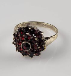 ☆Like what you see? I consider all reasonable offers!☆ *Size 6.75 *Weighs 3.5 grams *Highly Collectible Bohemian Garnet Cluster ring dating from the 1900s. This particular ring is slightly larger than most, so it's a particularly fun find! *Two halos of wine colored,  sparkling, rose cut garnets surround the main, bezel set gemstone.  *Set in 900 silver & lightly washed in gold. *Hallmarked 900 in old fashioned hallmark. *This ring was found at an Estate sale. *This ring dates from the 1900s & i Sparkling Rose, Wine Colored, Cluster Ring, Bezel Setting, Rings Statement, Rose Cut, Estate Sale, Old Fashioned, Statement Rings