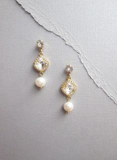 These elegant earrings are made with Swarovski crystals and fine quality culture freshwater pearls. These dangling drop earrings feature fancy cushion cut Swarovski crystals in crown settings finished with a large pearl drop. Available in gold or silver finish. - Measurements :   1 3/4" long  and 5/8" wide at the widest point- Post earrings with butterfly ear-nuts Emerald Cut Drop Earrings, Fancy Cushions, Bridal Pearl Earrings, Gem Hair, Earrings Dangling, Crystal Bridal Earrings, Bridal Earrings Pearl, Swarovski Crystal Earrings, Earrings In Gold