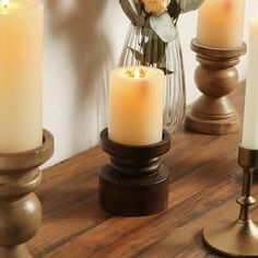 some candles are sitting on a wooden table