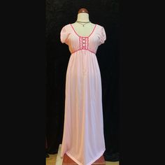 Vintage pastel pink long nightgown.  Shoulder cap sleeves  Magenta trim around neckline and bust.  Three magenta buttons down the bust.  This beauty had two tiny holes on the front in which I put two tiny floral appliqués to cover.  To sweet not to list.  Women's size Large Please ask for measurements if interested.  Thank you. Pink V-neck Nightgown With Lace Trim, Vintage Pink Sleep Dresses, Pink Vintage Sleep Dress, Vintage Pink V-neck Nightgown, Pink Fitted V-neck Nightgown, Feminine Pink Short Sleeve Nightgown, Pink Short Sleeve Sleepwear With Lace Trim, Pink Lace Trim Dresses For Bedtime, Fitted Pink Nightgown For Sleep