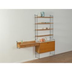 a shelf that has some items on it next to a table with drawers and shelves