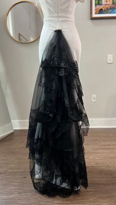 a black and white dress on display in front of a mirror