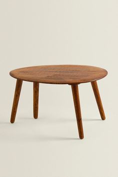 a small wooden table with two legs and a round top, on a white background