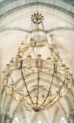 a chandelier hanging from the ceiling in a church