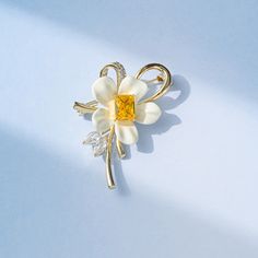 Elevate your outfit with this stunning Copper Yellow Diamond Flower Brooch. Adorned with intricately cut yellow diamonds, this brooch adds a touch of elegance to any ensemble. The perfect accessory for a special occasion or to elevate your everyday look.      Tarnish proof    Water proof    Sleep / Nap proof    Safe for sensitive skin    Wear it while working out &showering    Designed to wear 24/7    If there is no stock, the product will take   60    days to produce    Please leave your usual Elegant Yellow Brooches For Gifts, Yellow Brooch Jewelry For Wedding, Yellow Wedding Jewelry Brooch, Yellow Flower-shaped Formal Jewelry, Formal Yellow Flower-shaped Jewelry, Elegant Yellow Flower Brooches, Elegant Gold Flower Brooch, Elegant Gold Flower Brooches, Elegant Yellow Brooches For Party