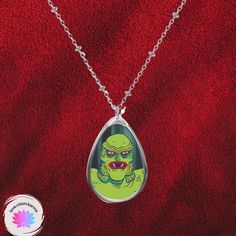 Our Creature from the Black Lagoon pendant necklace will make you or your horror-movie-loving sweetie scream with joy this Valentine's Day! The lightweight, oval shaped pendant has a white aluminum surface that features a glossy image of the Creature, while the brass chain and lobster clasp closure will keep the necklace securely in place, if ever you need to high tail it away from an actaul monster! :) Meant for fun, wear this kitschy necklace to your next outing and let your friends know that Halloween Teardrop Jewelry Gift, High Tail, Creature From The Black Lagoon, The Black Lagoon, Oval Pendant Necklace, Black Lagoon, Movie Monsters, Brass Necklace, Aluminum Prints