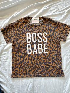 Boss Babe Leopard Graphic Tee – Mota Boutique Leopard Print T-shirt With Letter Print And Crew Neck, Trendy Leopard Print Graphic T-shirt, Casual Stretch Tiger Print Tops, Leopard Print Graphic T-shirt For Summer, Summer Leopard Print Graphic T-shirt, Trendy Leopard Print Top With Lettering, Leopard Print Top With Letter Print For Summer, Summer Leopard Print Tops With Graphic Print, Summer Leopard Print Top With Graphic Design