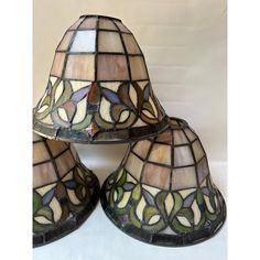 three stained glass lamps sitting next to each other