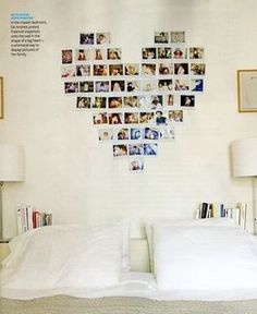 a heart shaped photo hanging on the wall above a bed with white sheets and pillows