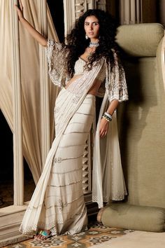 Ivory pre-draped saree with sequins and cutdana hand embellishments in placement floral and stripe pattern. Paired with a padded blouse with all over sequin, cutdana hand embellishments and cape with all over sequins, cutdana work. - Aza Fashions White Draped Pre-draped Saree For Wedding, Elegant White Pre-draped Saree, Saree Cape, Cutdana Work, Cape Set, Set Women, Sweetheart Neck, Set For Women, Cape