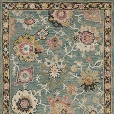 an area rug with many different colored flowers on it, including blue and pink colors