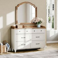 a white dresser and mirror in a room