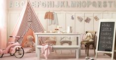 a child's playroom with pink furniture and accessories, including a teepee tent