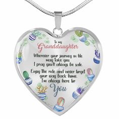 a heart shaped necklace with the words granddaughter written in white and colorful designs on it