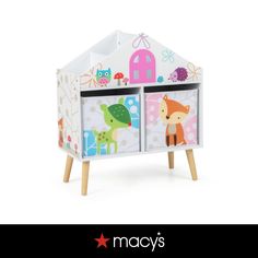 a toy house with animals painted on the front and sides, sitting on top of wooden legs