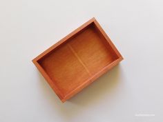 an empty wooden box sitting on top of a table