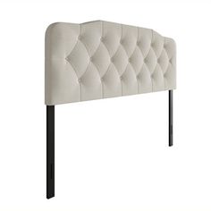 an upholstered headboard with black metal legs