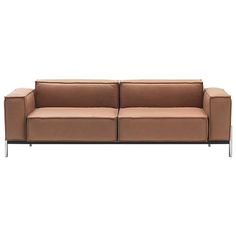 a brown leather couch sitting on top of a white floor