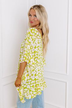 - Perfect for a stylish look on a sunny day, this trendy top will keep you looking fabulous! - Unlined, lightweight material in a gren hue with an abstract floral design - A v-cut neckline as well as a v-cut back - Draped half sleeves with ruffle detail - A relaxed silhouette that ends in an uneven ruffled hemline Green Printed Tops For Vacation, Green V-neck Top With Vibrant Print, Trendy Lime Green Summer Tops, Green Printed V-neck Top, Green Flowy V-neck Top, Flowy V-neck Spring Blouse, Green Printed Spring Tops, Chic Green Top For The Beach, Green V-neck Top For Beach