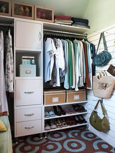 an organized closet with clothes and handbags hanging on the wall next to it is shown