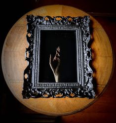 a wooden table topped with a framed picture