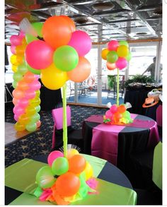 balloons and streamers decorate tables at an event