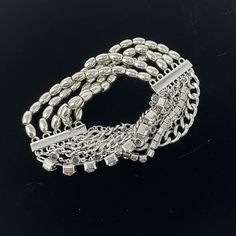 "🌼 Multi strand Silver tone stretch bracelet with chain, beads and rhinestones by Chicos. 🌼 Measures: 1 1/4\" wide.  The beads are stretchy so will fit most wrists. 🌼 Condition: very good, minimal wear. Please see all photos for complete details. For more vintage jewelry in my shop, please visit: https://www.etsy.com/shop/TheVintageDaisyVault?ref=seller-platform-mcnav&section_id=25440304" Beaded Multi-strand Metal Bracelets, Elegant Beaded Metal Charm Bracelet, Party Jewelry With Beaded Metal Chain, Party Bling Metal Bracelets, Silver Stretch Bracelet With Faceted Beads For Party, Silver Beaded Chain Bracelets, Silver Beaded Ball Chain Bracelet, Elegant Silver Metal Bead Bracelets, Elegant Silver Metal Beads Bracelets