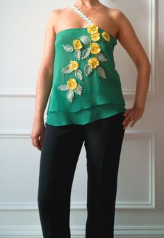 "Enhance your unique style with this luxurious silk top in a lively bright green color! The off-shoulder design creates a trendy and sensual look, while the handmade floral crochet appliques in Irish style, embellished with beads, add a delicate and romantic touch to your outfit. Each piece is carefully and passionately handmade, making this silk top one-of-a-kind. Let yourself be conquered by its elegance and sophistication, and you'll surely attract attention wherever you go. Don't miss the op Crochet Application, Green Silk Top, Crochet Appliques, Irish Style, Floral Crochet, Bare Shoulders, Crochet Applique, Top Top, Crochet Flower