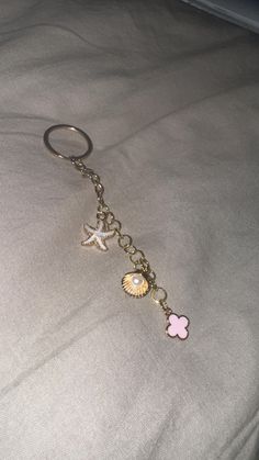 a keychain with two seashells and a starfish hanging from it