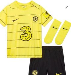 a yellow shirt and black shorts with the number 3 on it is next to socks