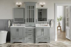 a white bathroom with two sinks and mirrors