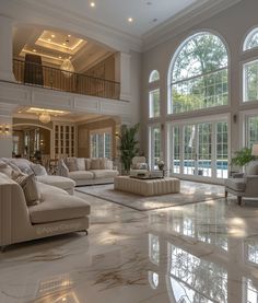 a large living room with high ceilings and big windows on the wall, along with marble flooring