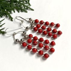 Long dangling beaded earrings made of sterling silver and red coral.  The wire has some subtle bends (see photos), but they are otherwise in great vintage condition.  The ear hooks are marked '925', and I've also tested them with nitric acid to confirm they are completely sterling silver. Length: 2.85 inches (73 mm) Weight: 11.7 grams Message if you have any questions  : )   Vintage jewelry: good for humanity and the earth. By buying preowned jewelry, you have avoided supporting the harmful mini Red Sterling Silver Beaded Earrings, Red Sterling Silver Wire Wrapped Earrings, Nickel-free Red Beaded Sterling Silver Earrings, Red Sterling Silver Nickel-free Beaded Earrings, Red Beaded Sterling Silver Earrings, Red Sterling Silver Beaded Earrings Gift, Red Nickel-free Chandelier Earrings As Gift, Sterling Silver Dangle Jewelry With Polished Beads, Gift Sterling Silver Wire Wrapped Beaded Earrings