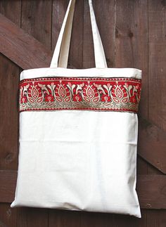 a red and white bag hanging on a wooden door