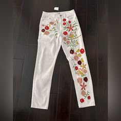 a pair of white pants with flowers on them