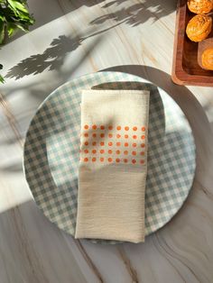 an orange dotted napkin sits on top of a plate