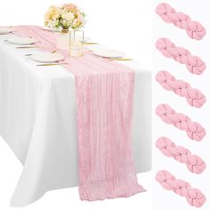 the table is set with pink napkins and place settings