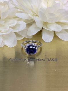 Cushion cut ceylon blue sapphire engagement ring, with natural round diamond accents 14k white gold # 5891 #DiamondRing #CeylonBlue #WeddingRing #SapphireRing #AnniversaryGift #BlueSapphire #EngagementRing #WhiteGold #HolidayGift #DiamondHalo Royal Blue Sapphire Diamond Ring, Blue Sapphire Rings With Diamond Accents, Cushion Cut Sapphire Ring With Cubic Zirconia Accent Stones, Tanzanite Rings With Diamond Accents In Round Cut, Blue Lab-created Sapphire Diamond Ring For Promise, Tanzanite Rings With Diamond Accents Round Cut, Blue Tanzanite Birthstone Ring, Blue Tanzanite Diamond Ring With Accent Stones, Blue Sapphire Ring With Asscher Cut And Accent Stones