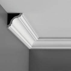 the corner of a white ceiling with black trim