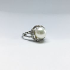 Our Ring Is Designed With White Freshwater Pearl in Round Shape, Cubic Zirconia And 925 Sterling Silver. You Can Wear It All Day Long. *Jewelry: Pearl ring *Size Of Ring: 14mm Length X 14mm Width X30mm height *Ring Size: Free size *Pearl Type: Freshwater Pearl *Pearl Grade: AAA *Pearl Luster: Excellent *Pearl Surface: Clean *Pearl Shape: Round/*Button *Pearl Color: *White/ Grey/ Pink /Black *Pearl Size: Approx 9-10mm *Metal: 925 Sterling Silver *Nice Jewelry Box Thanks For Choosing Blest Jewelle Classic White Gold Pearl Ring With Diamond Accents, Timeless White Gold Pearl Ring With Center Stone, Fine Jewelry White Gold Pearl Ring With Prong Setting, Brilliant Cut Diamond White Pearl Ring, White Gold Pearl Ring With Prong Setting, White Gold Pearl Ring With Diamond Center Stone, White Gold Pearl Ring With Diamond Accents For Promise, White Gold Pearl Ring With Center Stone, Round Cut, Elegant White Gold Halo Gemstone Ring