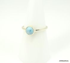 Introducing our newest gemstone ring: a stackable sterling silver minimalist larimar ring. These rings have a plain round 1.5mm band that is super comfortable and pairs perfectly with any outfit!A 6mm natural larimar cabochon is nestled in this beautiful 925 sterling silver setting. Each stone varies slightly, as shown in pictures.Add one (or several!) of these lovely rings to your collection before they are gone!Metaphysical Properties (not backed by scientific evidence):Larimar is also known a Minimalist Stackable Turquoise Ring, Larimar Ring, Larimar Rings, Minimalist Ring, Fall Jewelry, Lovely Ring, Minimalist Rings, Keep Jewelry, Gemstone Healing